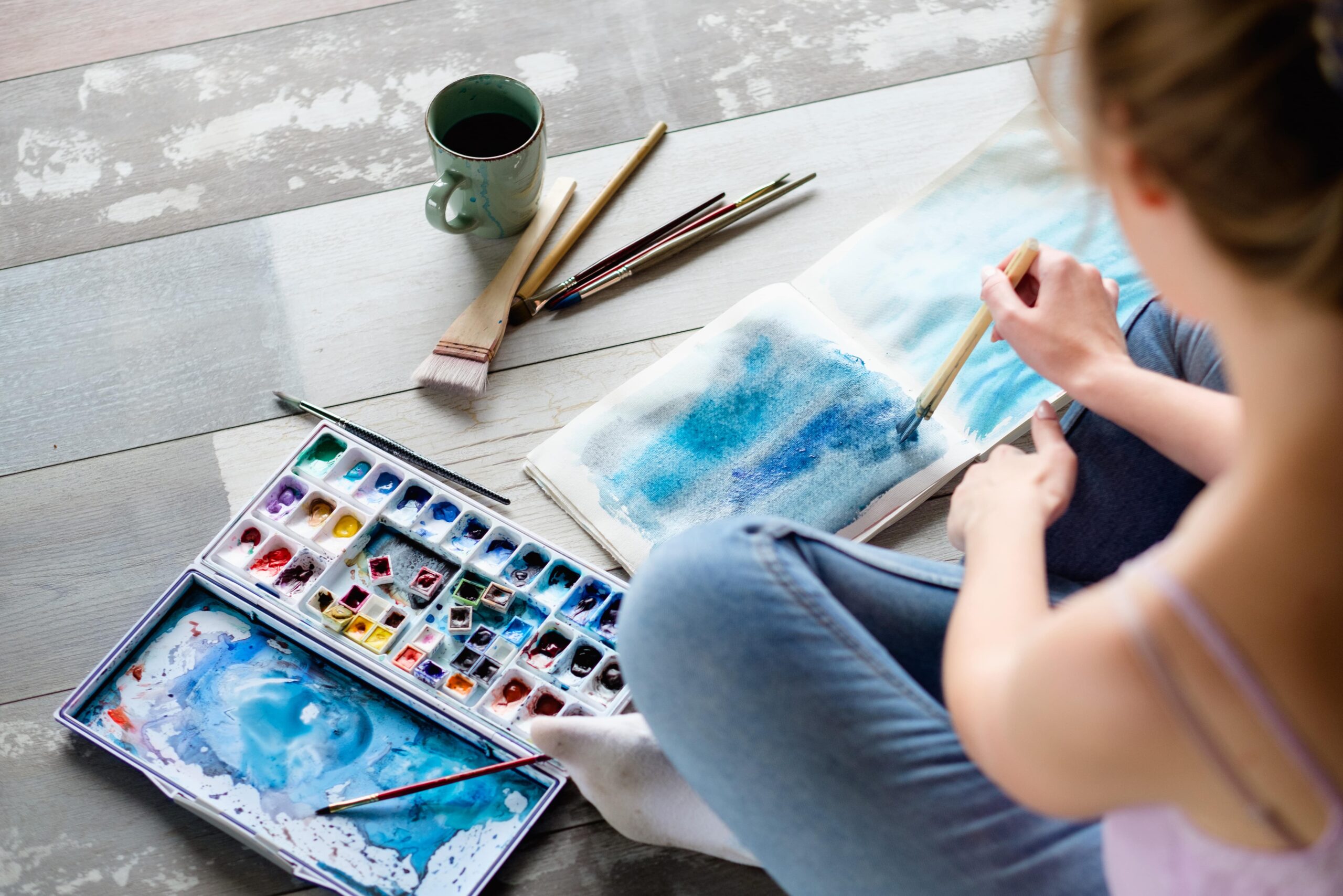 art therapy. painting classes or courses. creativity inspiration expression concept. woman drawing abstract blue painting
