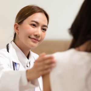 Asian female doctor giving hope and encourage to stressed woman patient