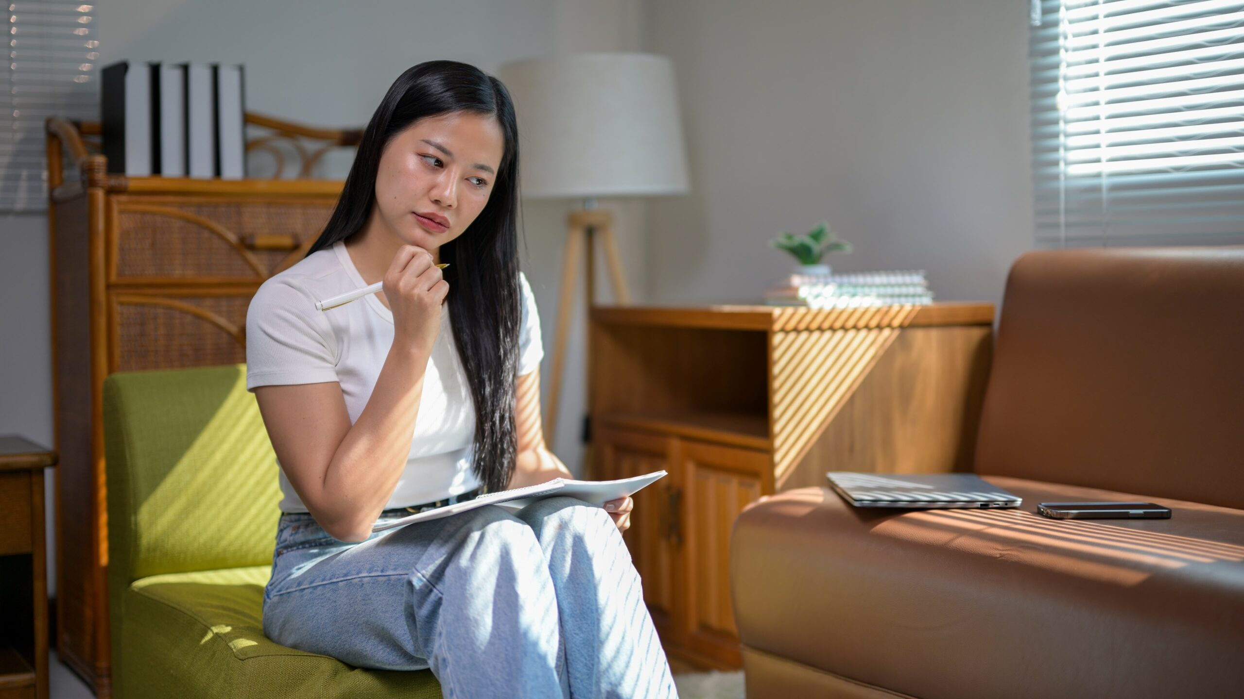 Person practicing reflection and self-care by journaling to stay positive during a tough day in recovery