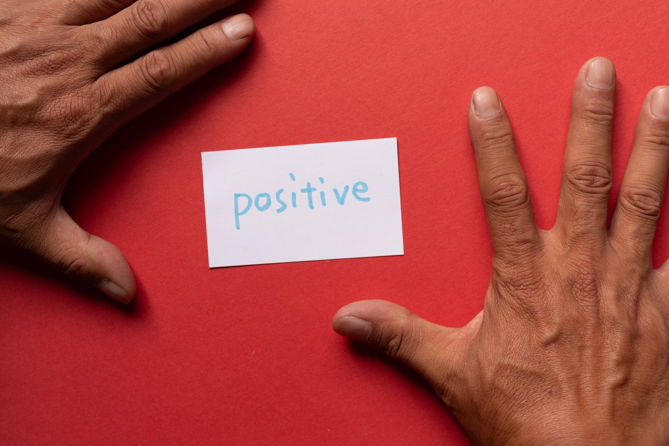 Person using a positive affirmation card to combat feelings of defeat in recovery.